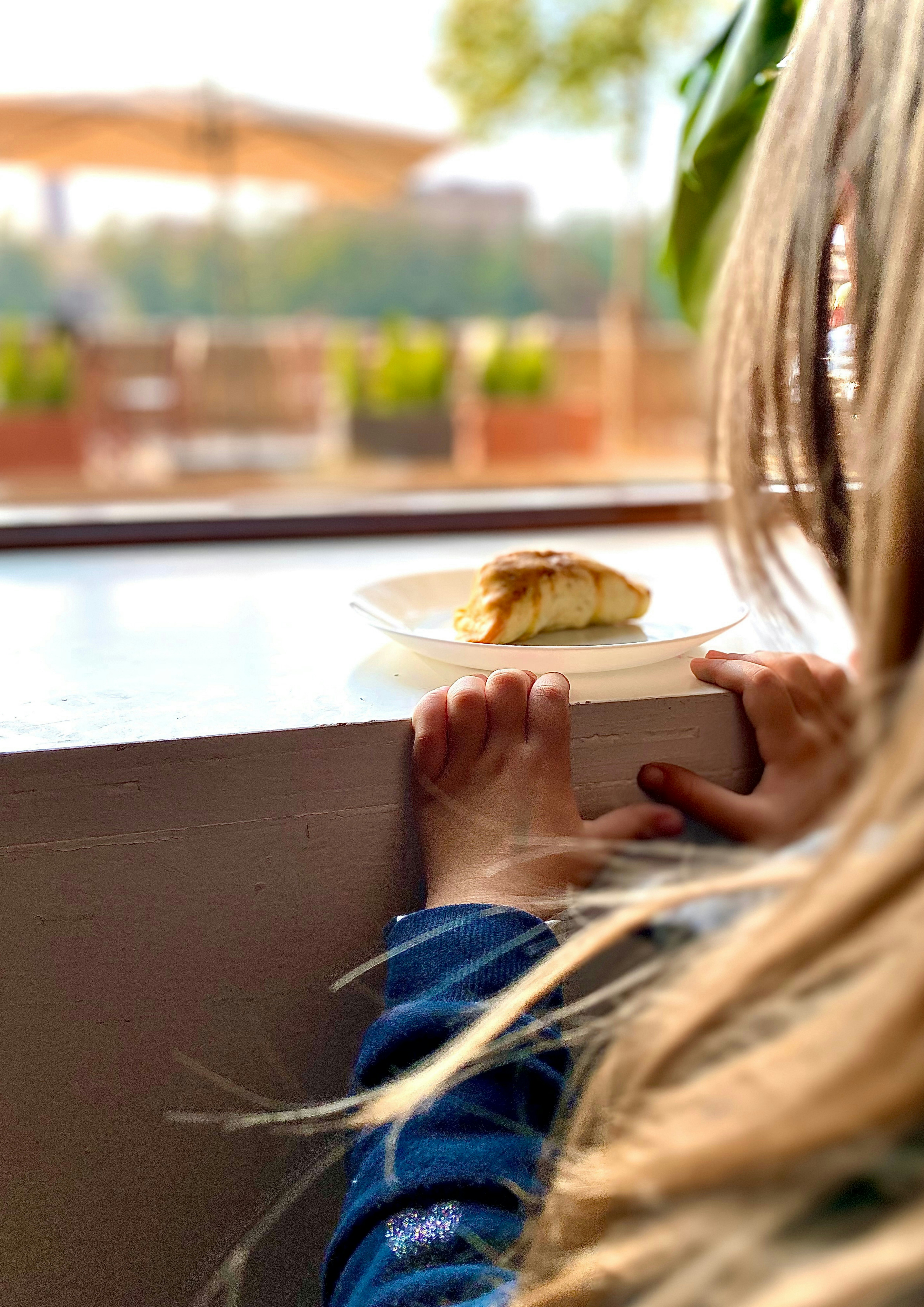 person holding white ceramic plate with food