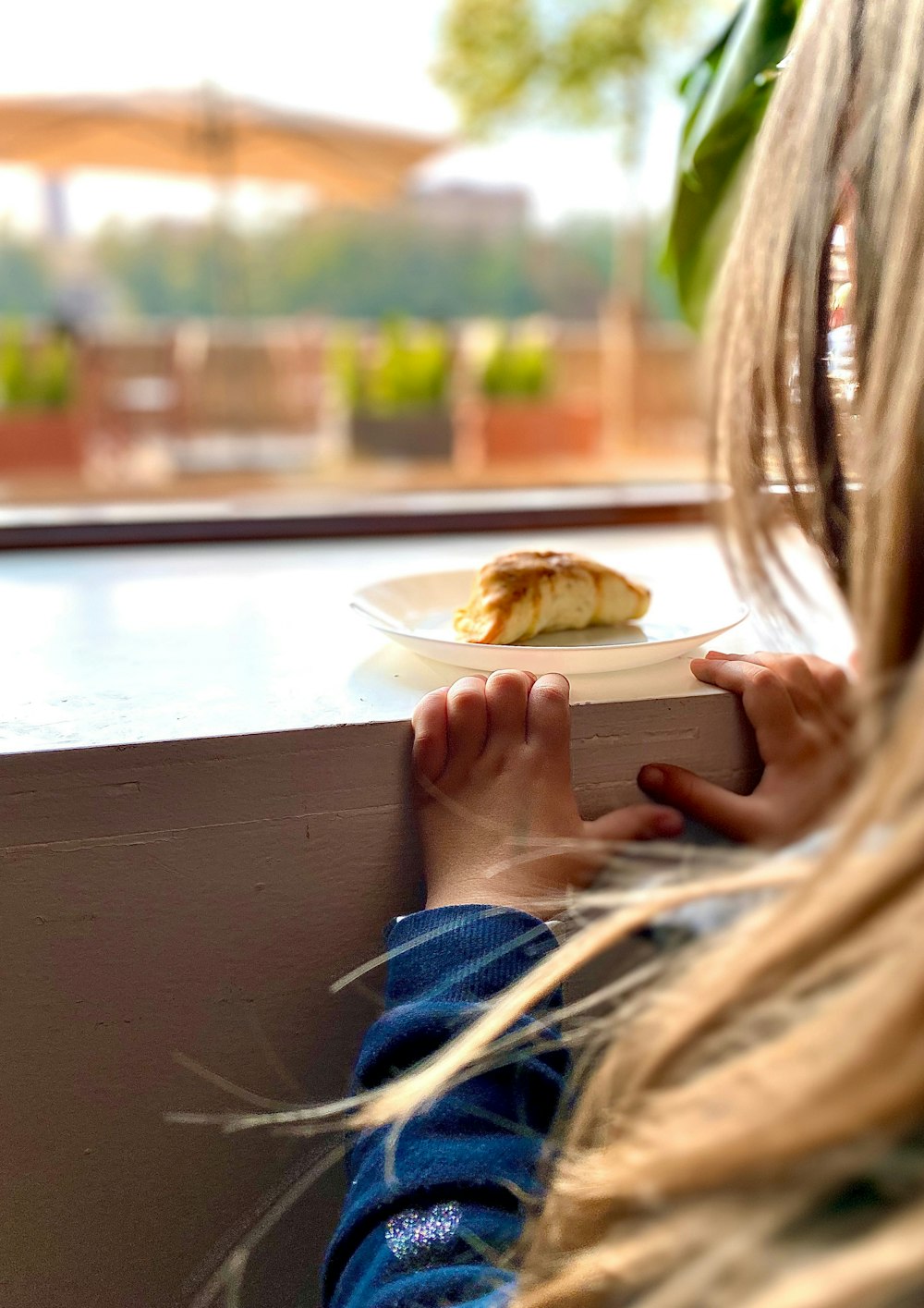 person holding white ceramic plate with food