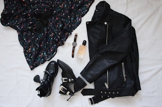 black leather belt on white textile