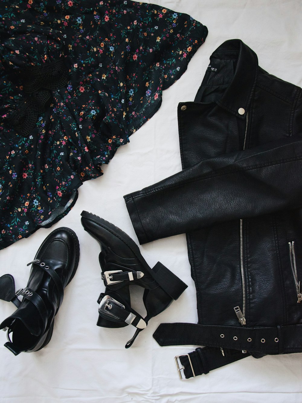 black leather belt on black and white floral button up shirt