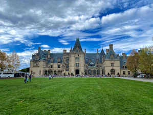 Visitors exploring the historic mansion during a sunny afternoon tour.