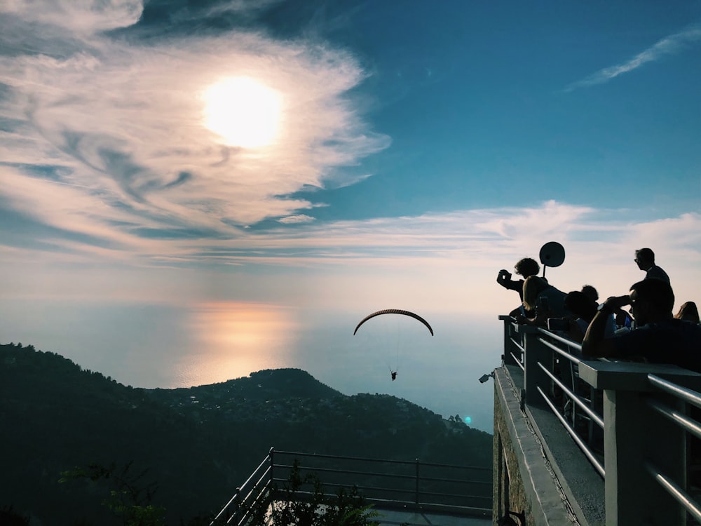 a group of people standing on top of a cliff