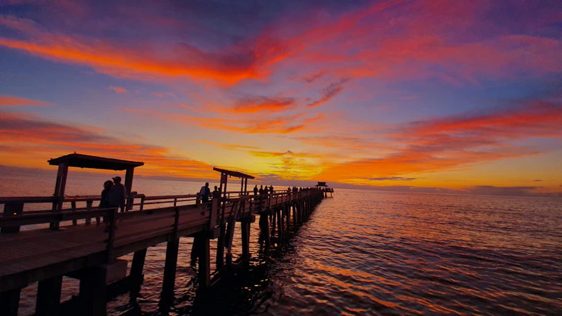 silhouette of wooden dock on Florida gulf during sunset
