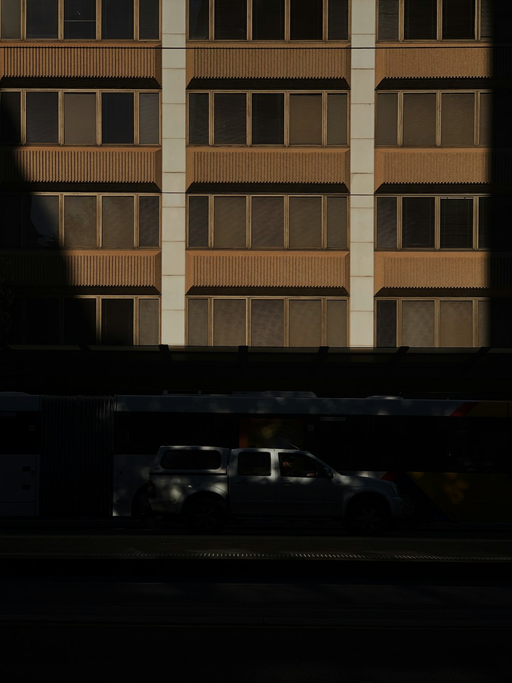 white and black cars parked in front of white building