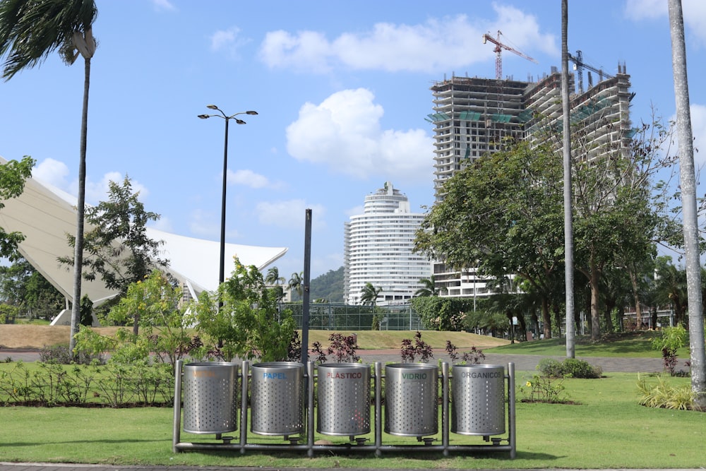 stainless steel trash bins on green grass field during daytime