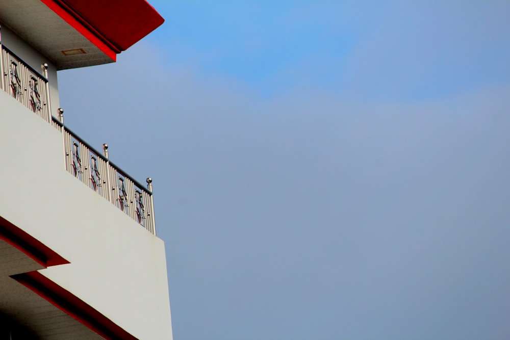 a bird is perched on the balcony of a building