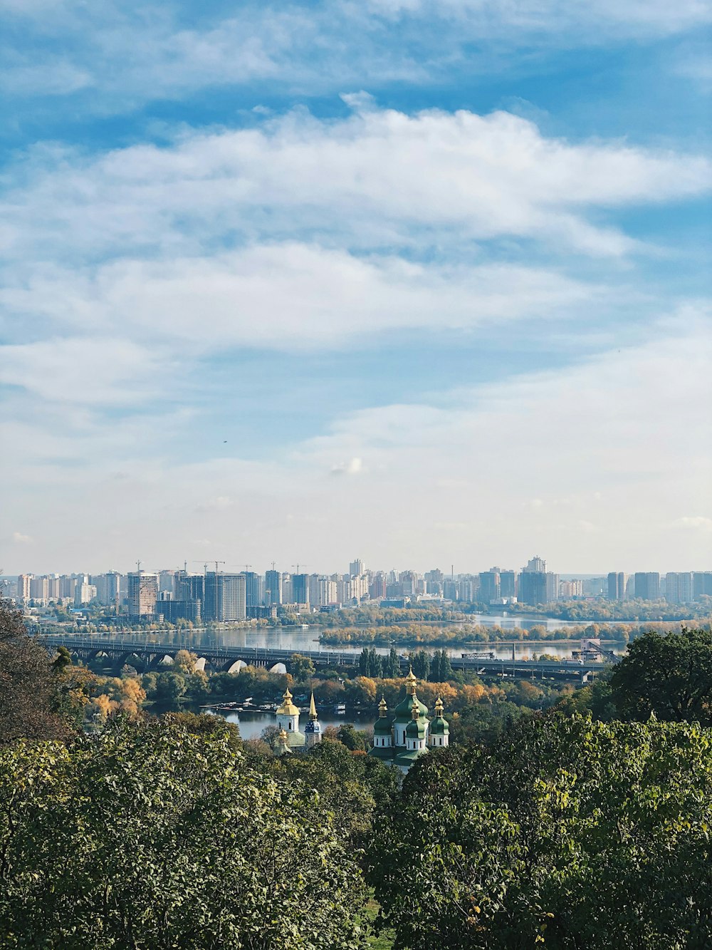 city buildings under white clouds during daytime