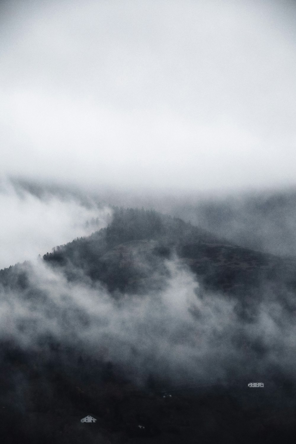 white clouds over green mountain