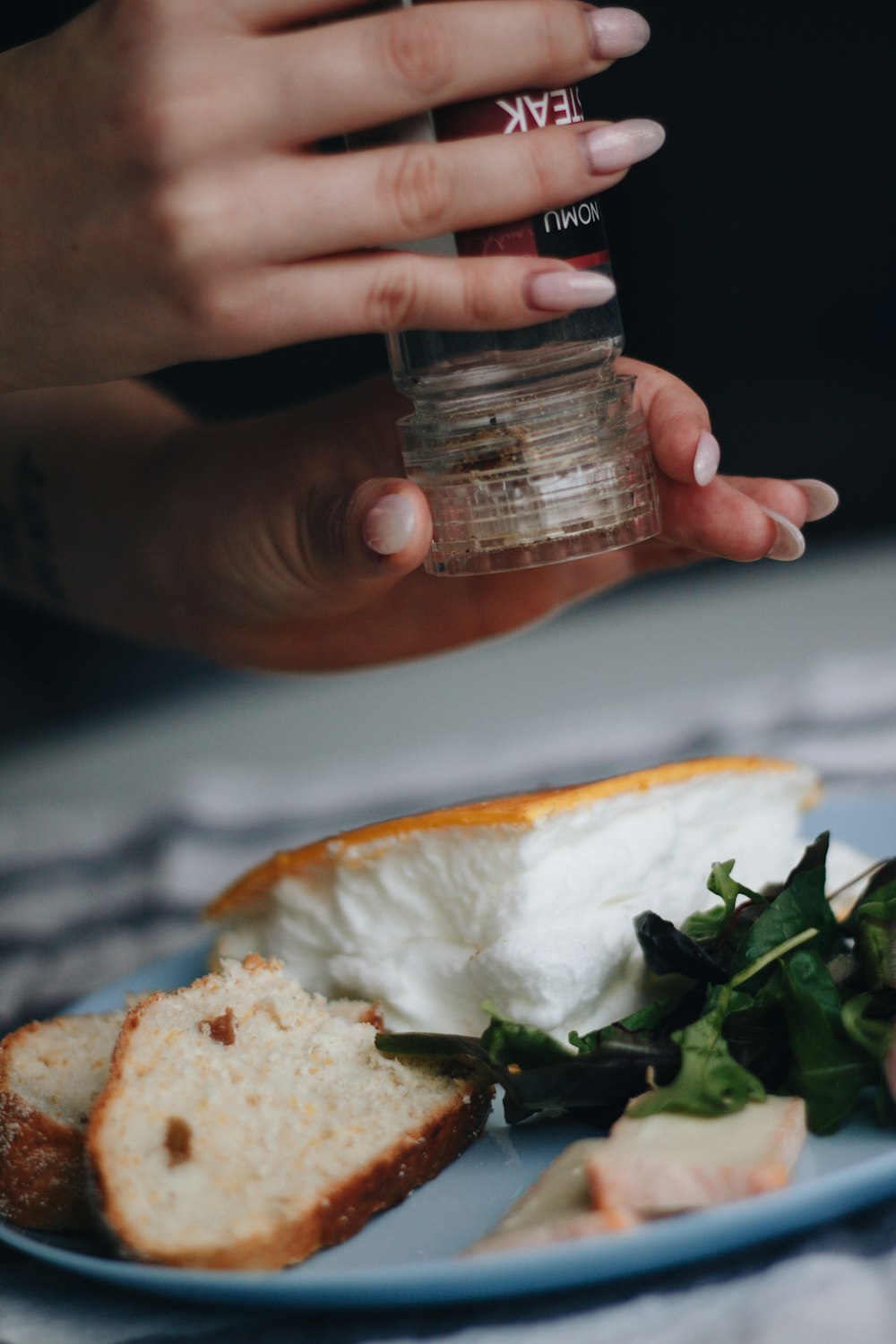 person holding clear glass jar