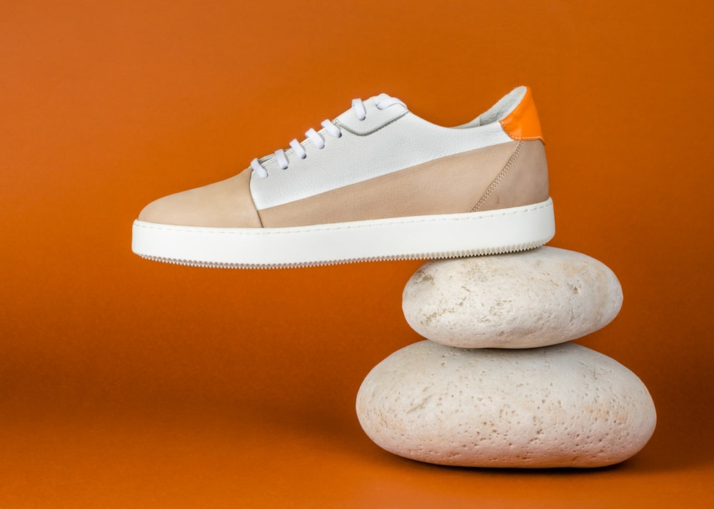 a pair of shoes sitting on top of a pile of rocks