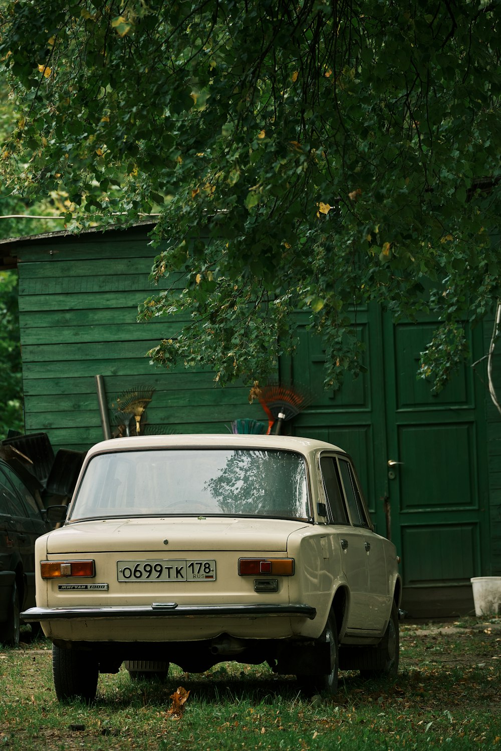 a car parked in front of a green building