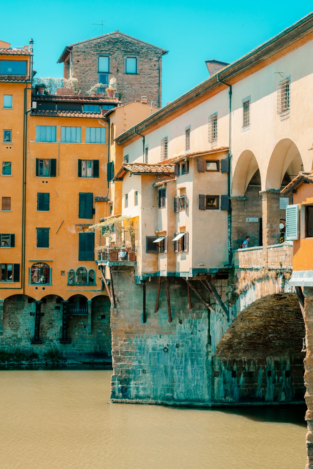 a bridge over a body of water in front of buildings