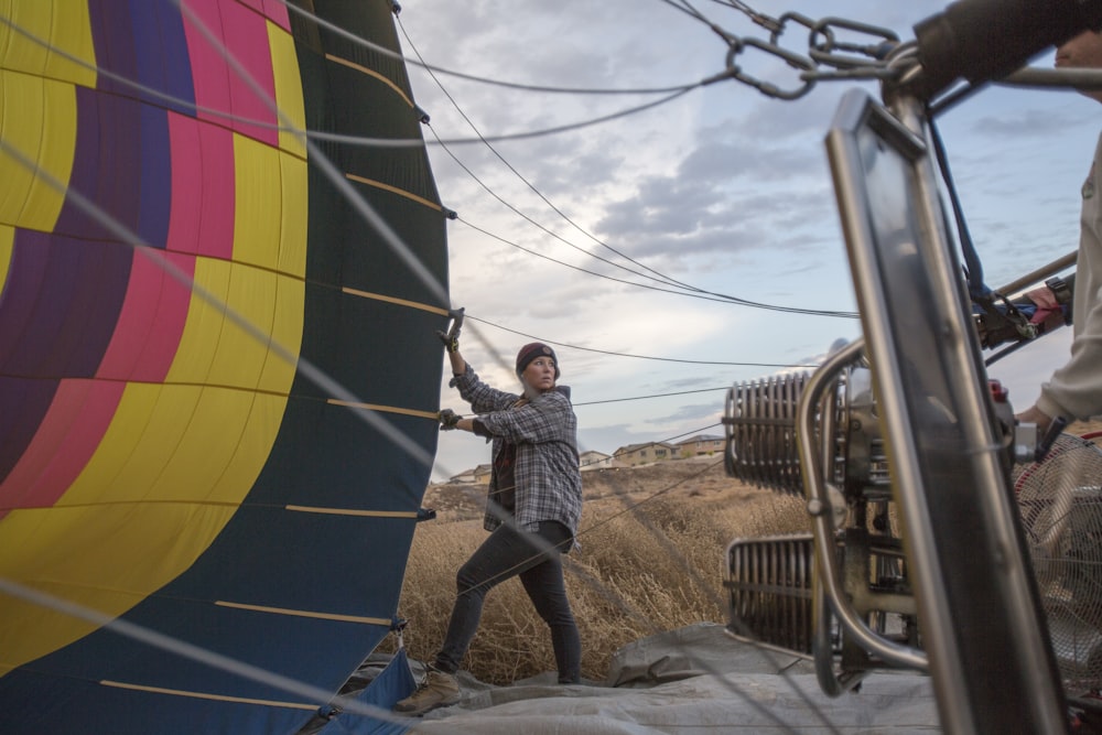 a man standing next to a hot air balloon