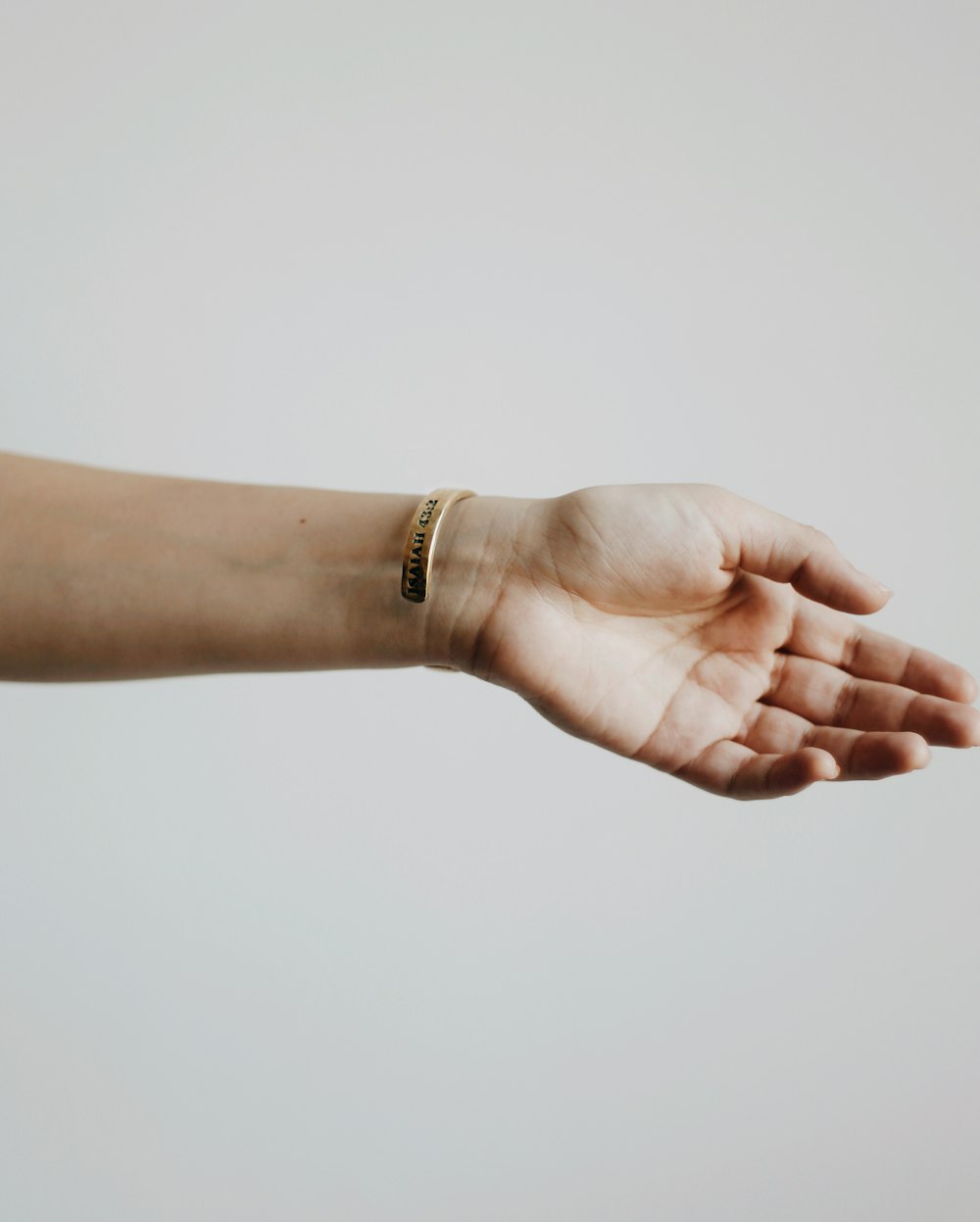 person wearing gold bracelet and gold bracelet