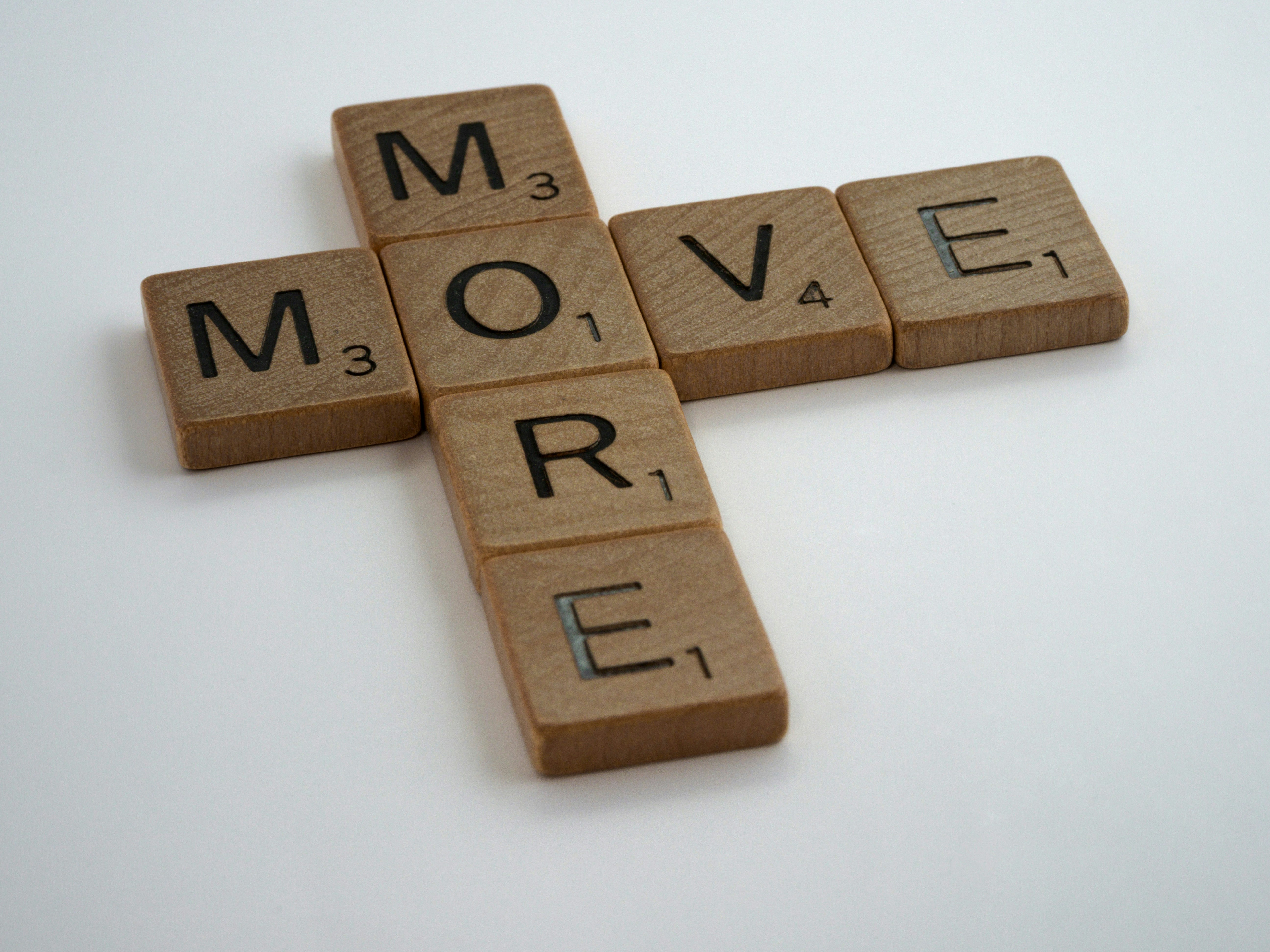 scrabble, scrabble pieces, lettering, letters, wood, scrabble tiles, white background, words, quote, move more, move, more, exercise, health, healthy lifestyle, step out, walk, get out of your seat, stop sitting, lazy, couch potato,<br>