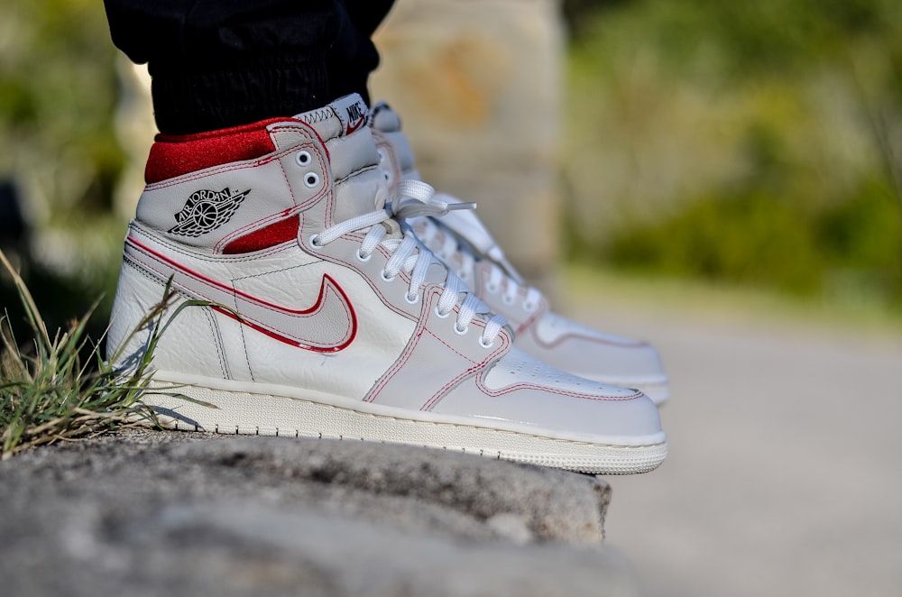 person wearing white nike air force 1 high