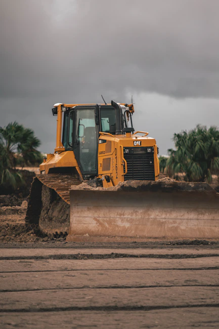 Heavy yellow and black equipment in a snowy forestry environment