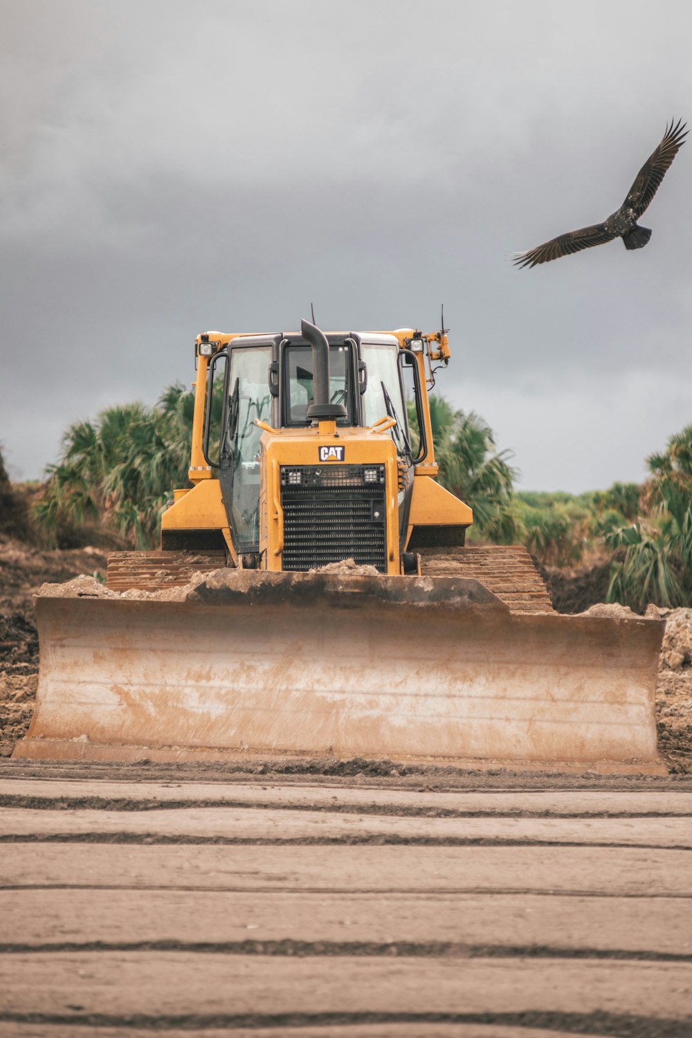 yellow and black heavy equipment on brown sand during daytime