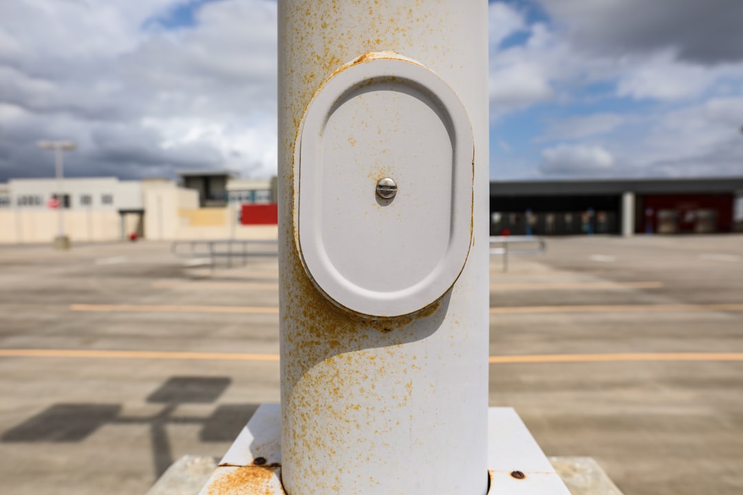 white round device on white post
