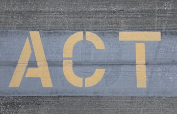 blue and white ACT print on gray concrete wall