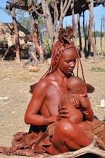 naked woman sitting on ground during daytime