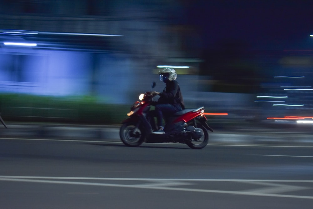 man in green jacket riding motorcycle on road during daytime