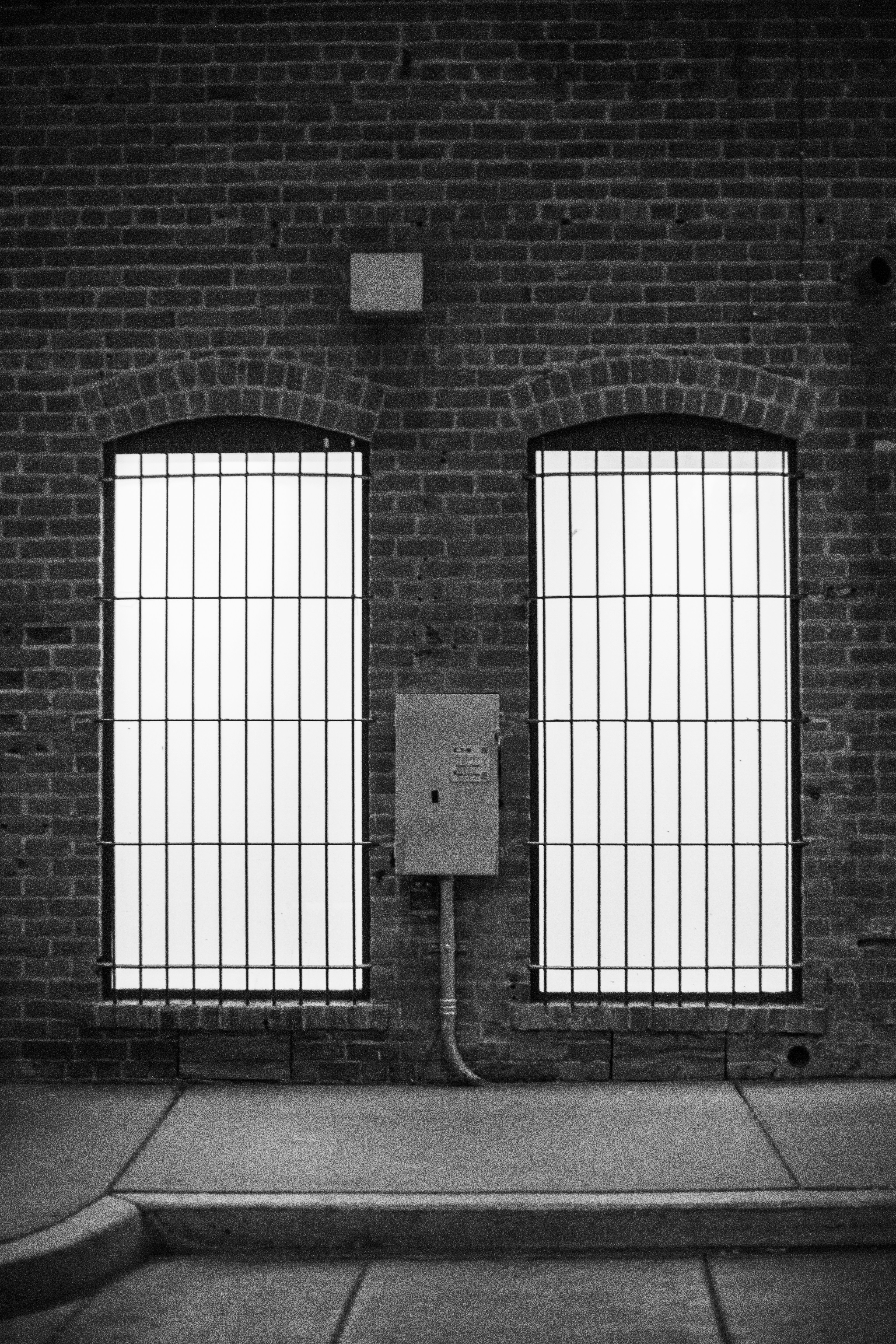 white wooden window frame on brown brick wall