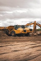 yellow and black heavy equipment on brown soil