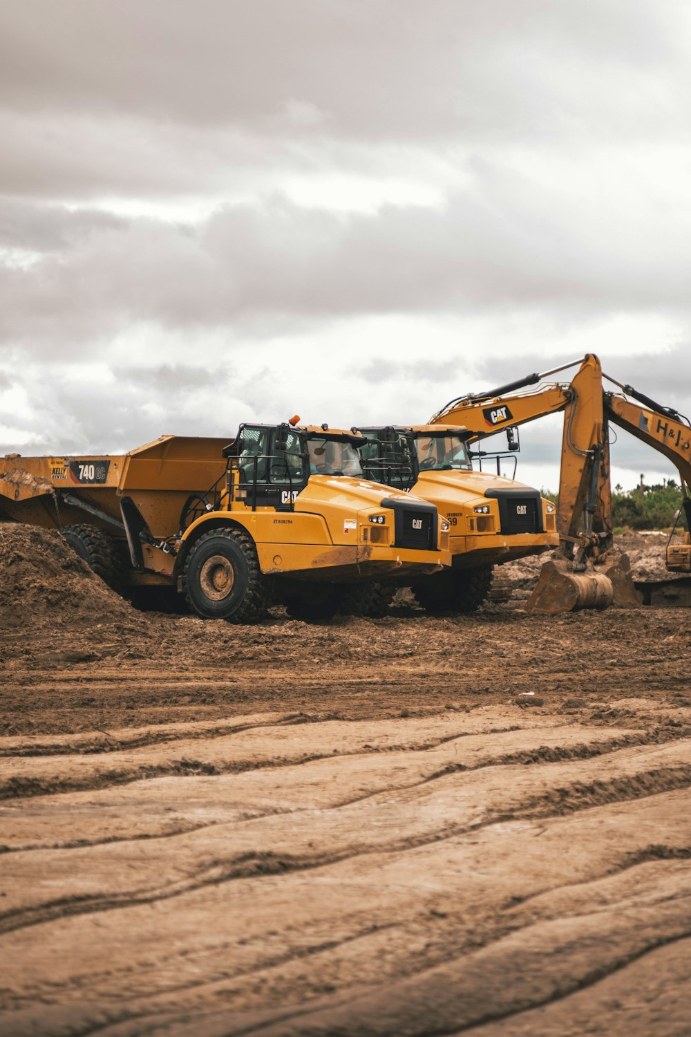 yellow and black heavy equipment on brown soil