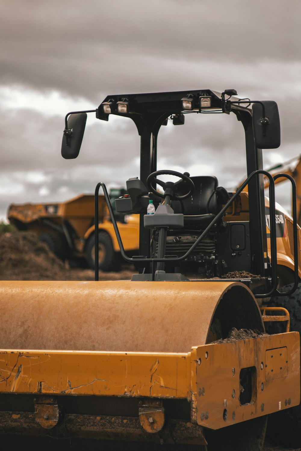 black and yellow tractor on yellow field