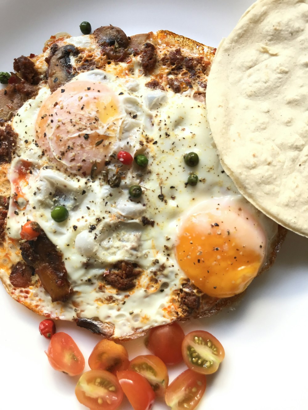 egg and meat dish on white ceramic plate