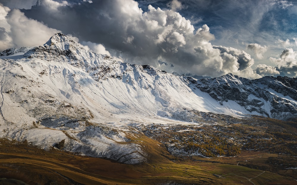 snow covered mountain under cloudy sky during daytime