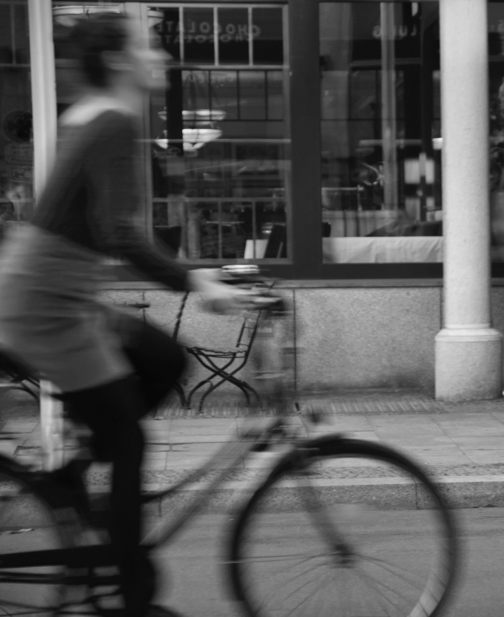 man and woman walking on sidewalk beside bicycle