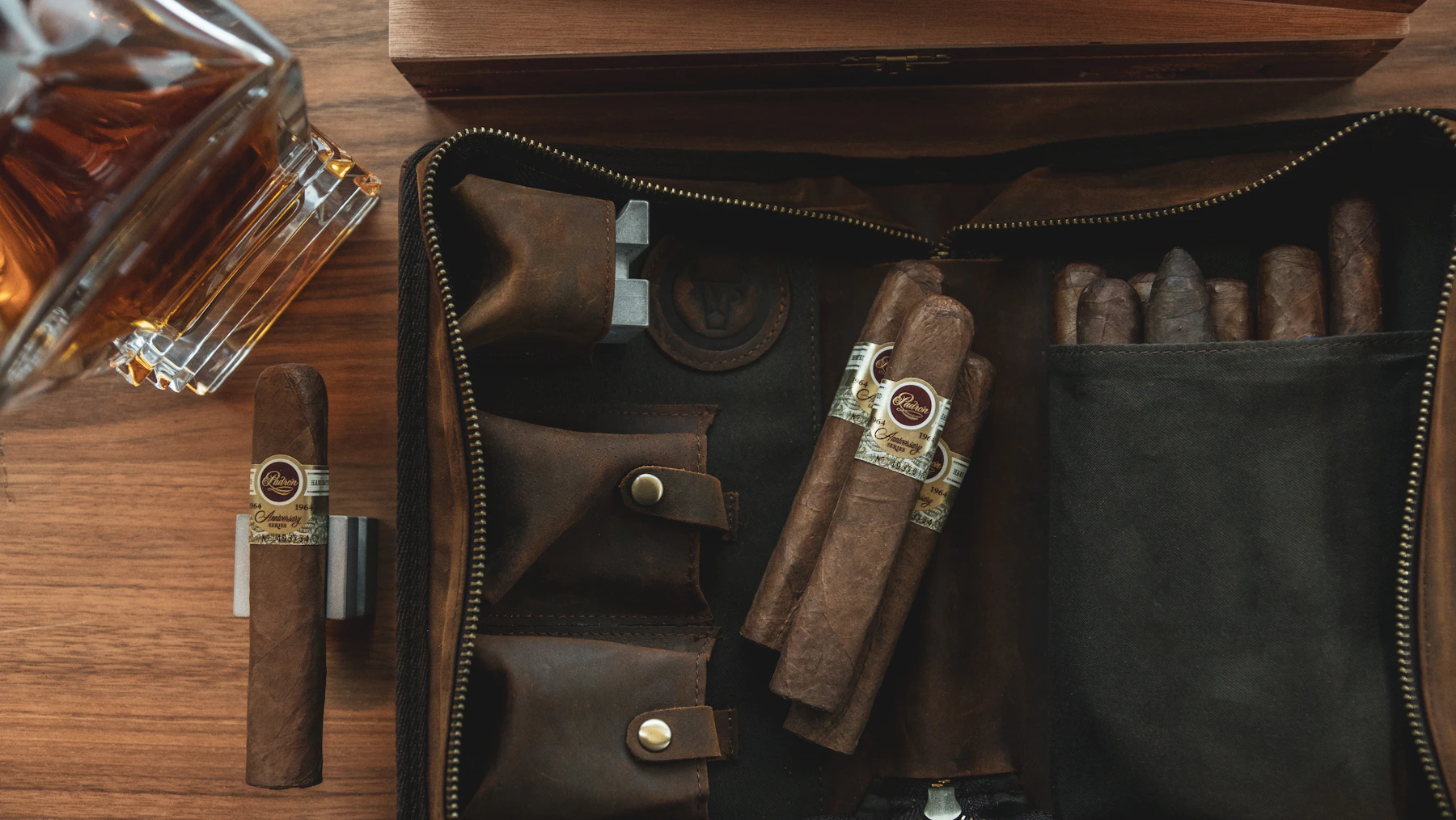 Premium cigars and travel accessories arranged inside a leather carrying case