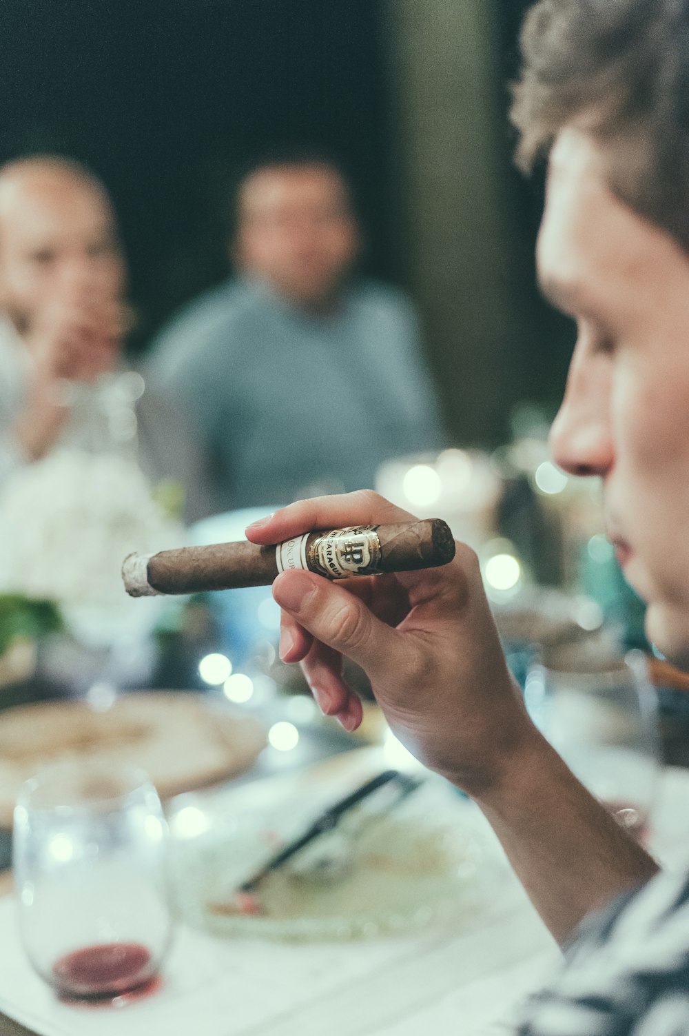 person holding brown tobacco stick