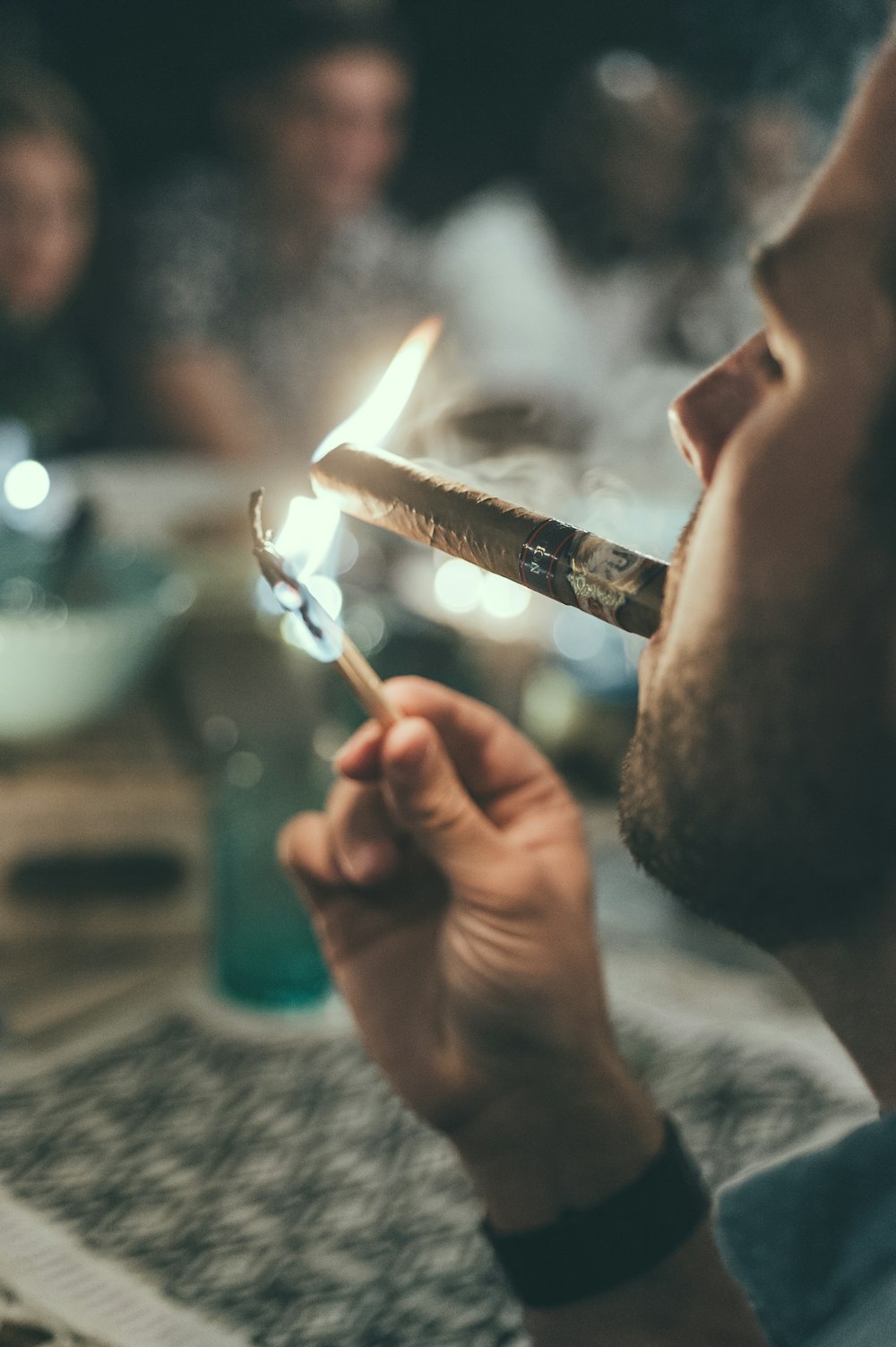 man smoking cigarette in front of table