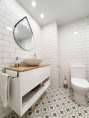 A bright bathroom renovation showcasing updated tile flooring and a stylish vanity.