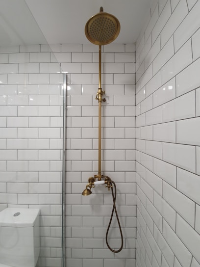 Private bathroom with modern fixtures and clean white tiles.