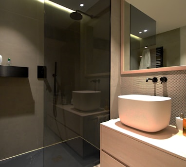 white ceramic sink near mirror