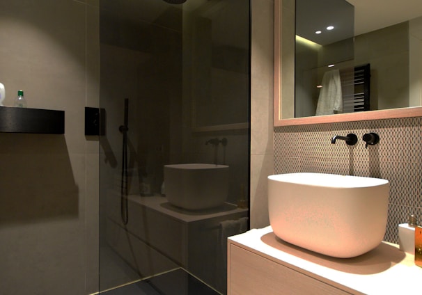 white ceramic sink near mirror