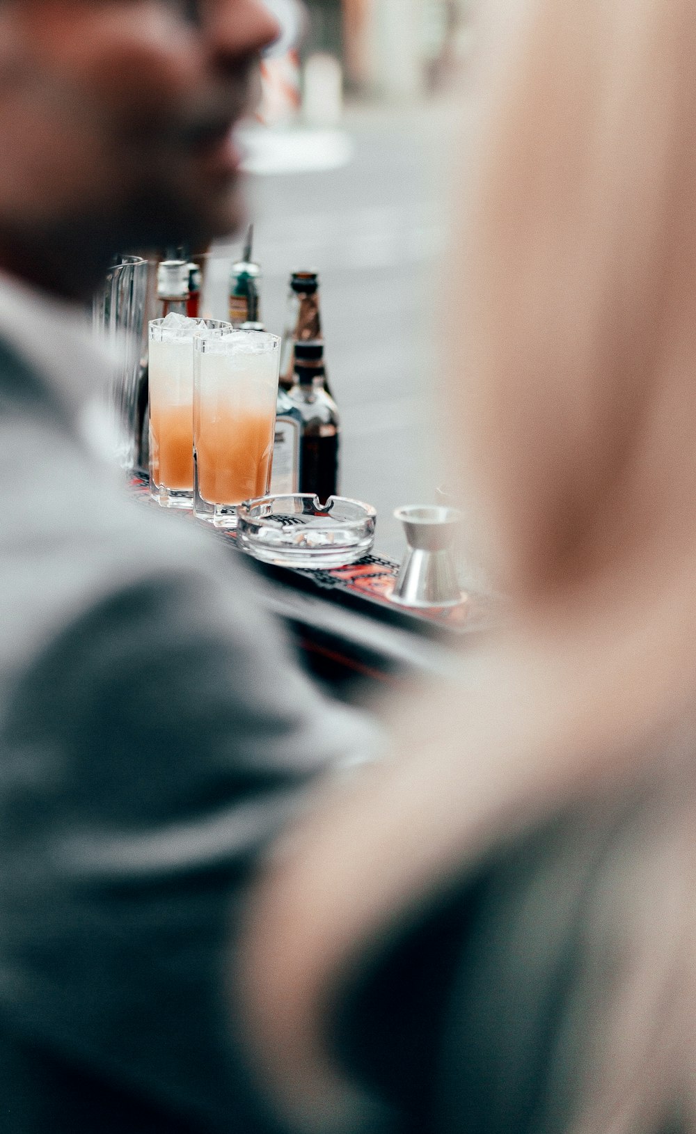 clear drinking glass with brown liquid on table