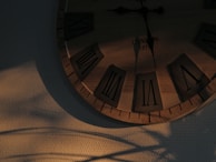 A restored grandfather clock glowing warmly in natural light, showing polished wood and shining glass.