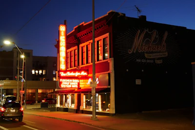 Bright neoflex lighting outlining a storefront sign at dusk.