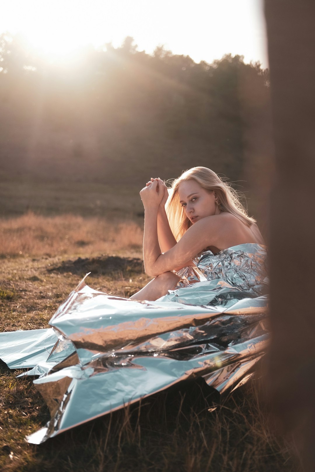 woman in blue and white floral dress lying on green grass field