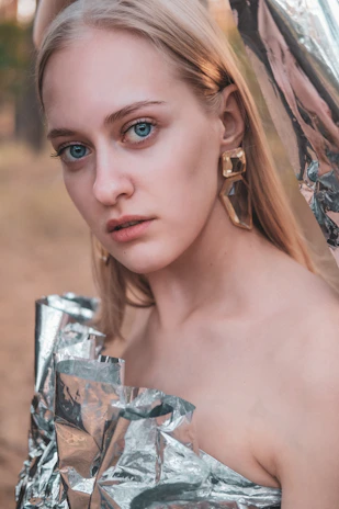 Soft-focus lifestyle shot of a woman wearing lumiraa jewellery in natural daylight.