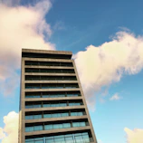 Modern condominium building with clear blue sky background.