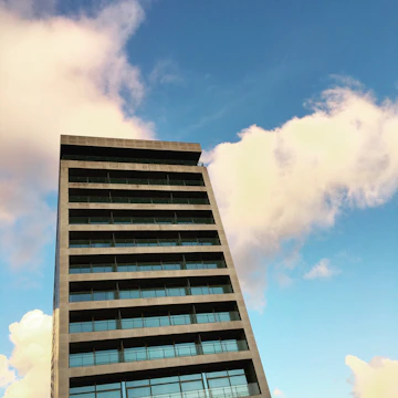 Modern condominium building with clear blue sky background.