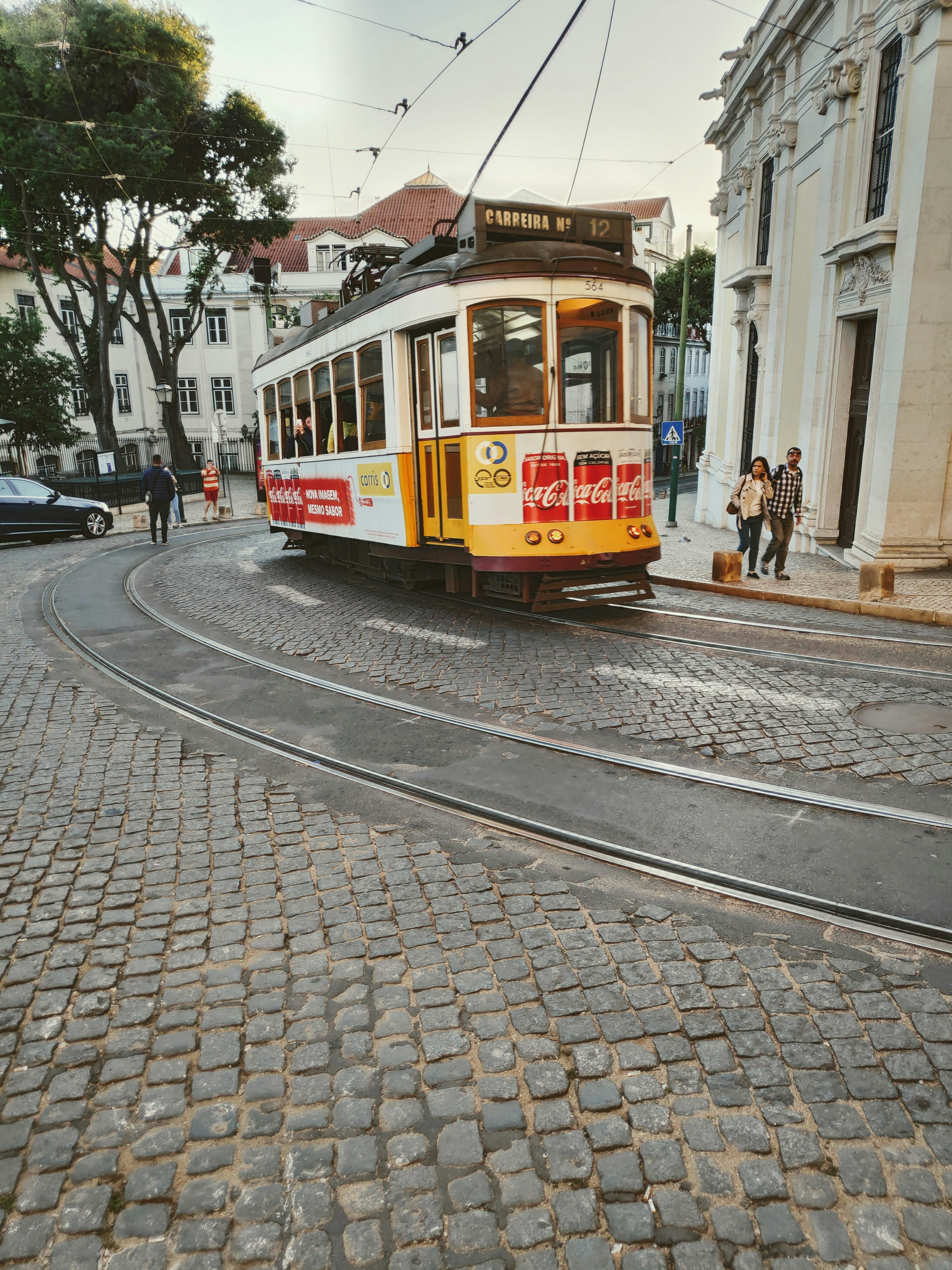 yellow and white tram on road during daytime