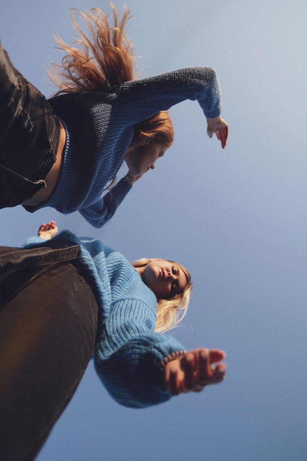 2 women standing on brown field during daytime