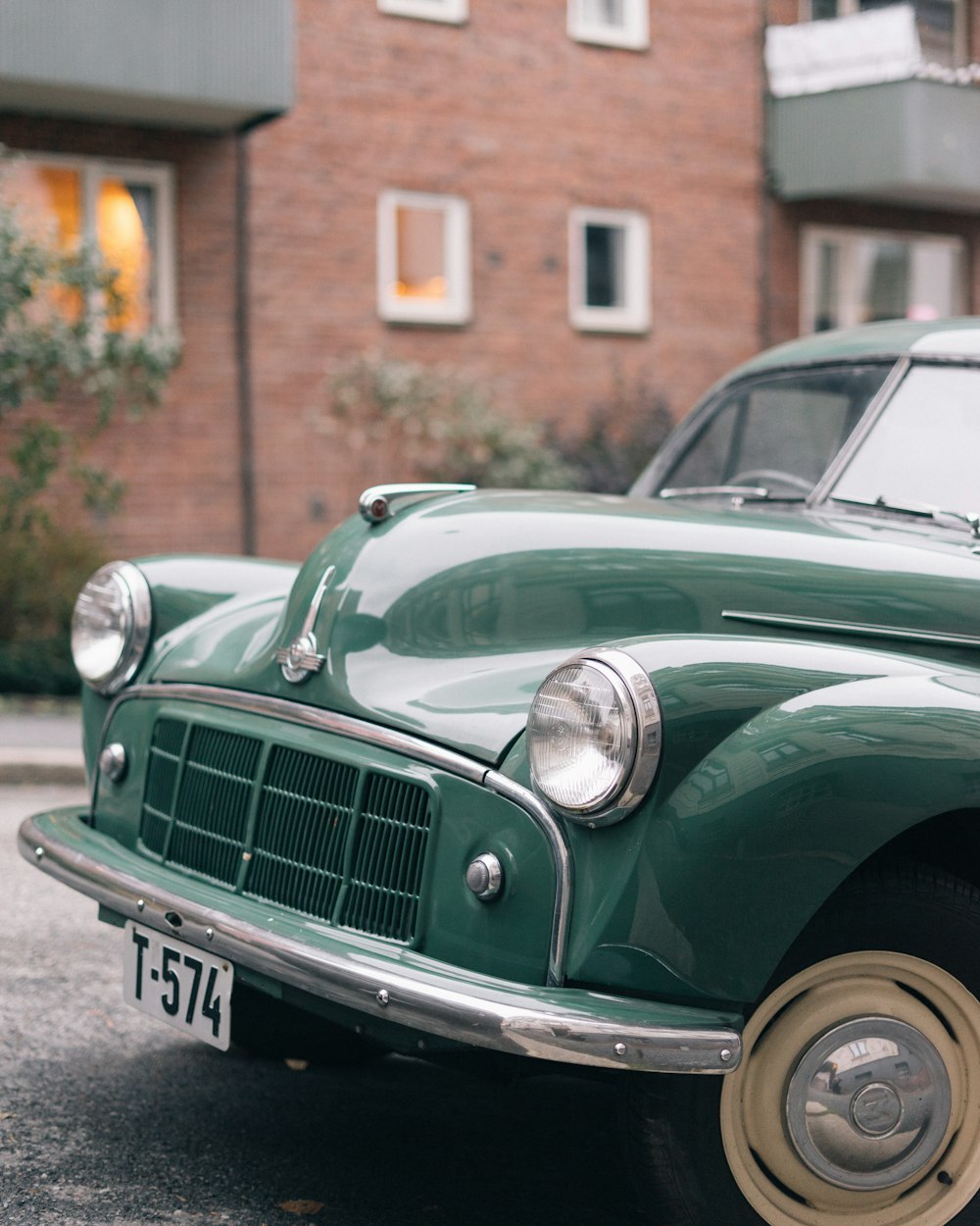 green classic car parked on street during daytime